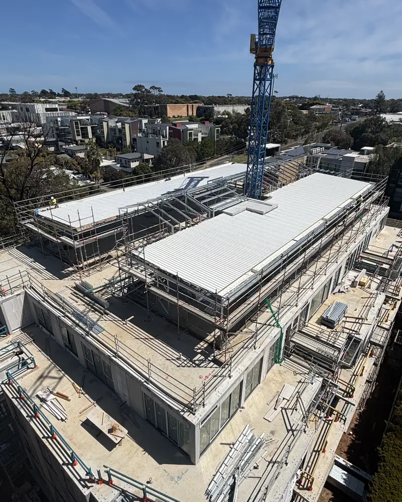 Large metal roof being installed on a commercial building