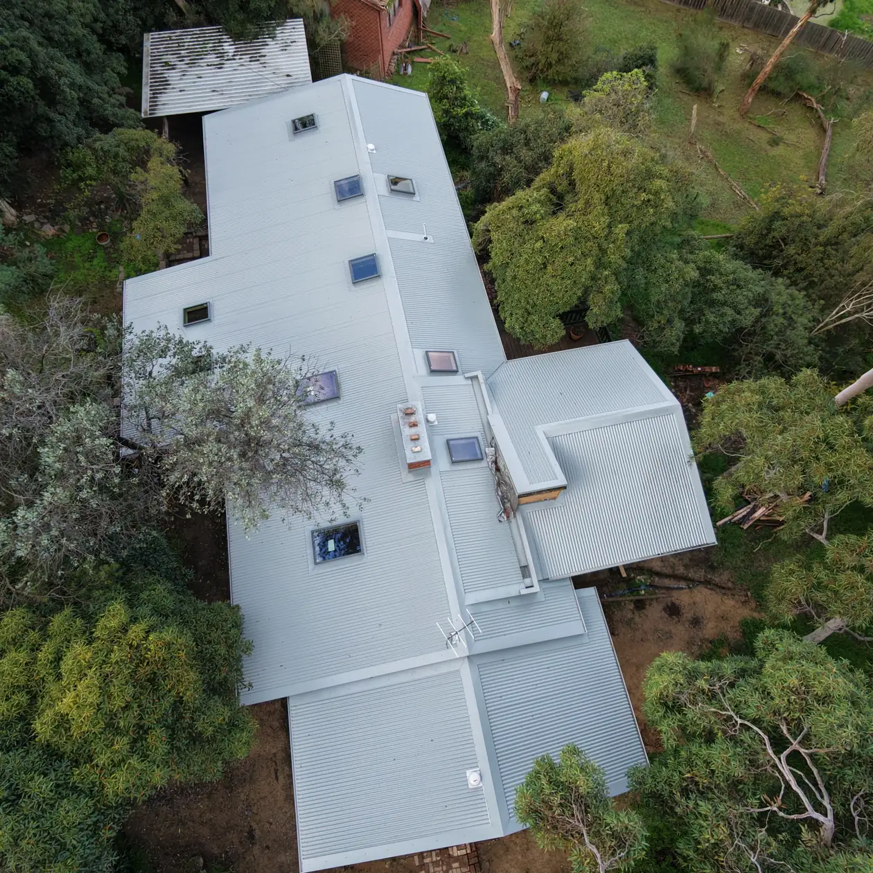 Completed metal re-roof seen from above on a large home
