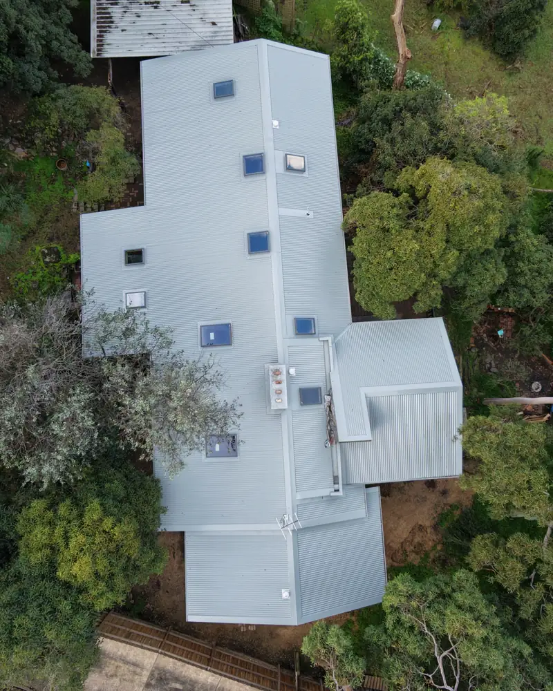New light grey metal roof replacing a badly rusted roof